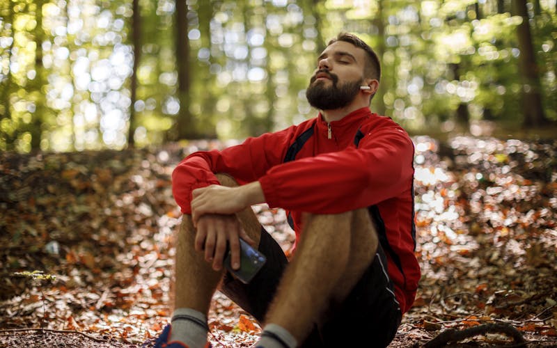 young man resting woods outdoors
