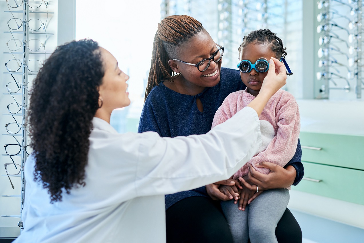 mother with child at optometrist for eye test
