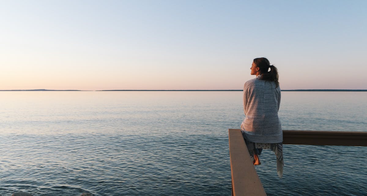 woman on beach gazing into sunset