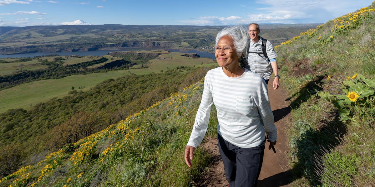 Mature Asian Woman Hiking on Hills
