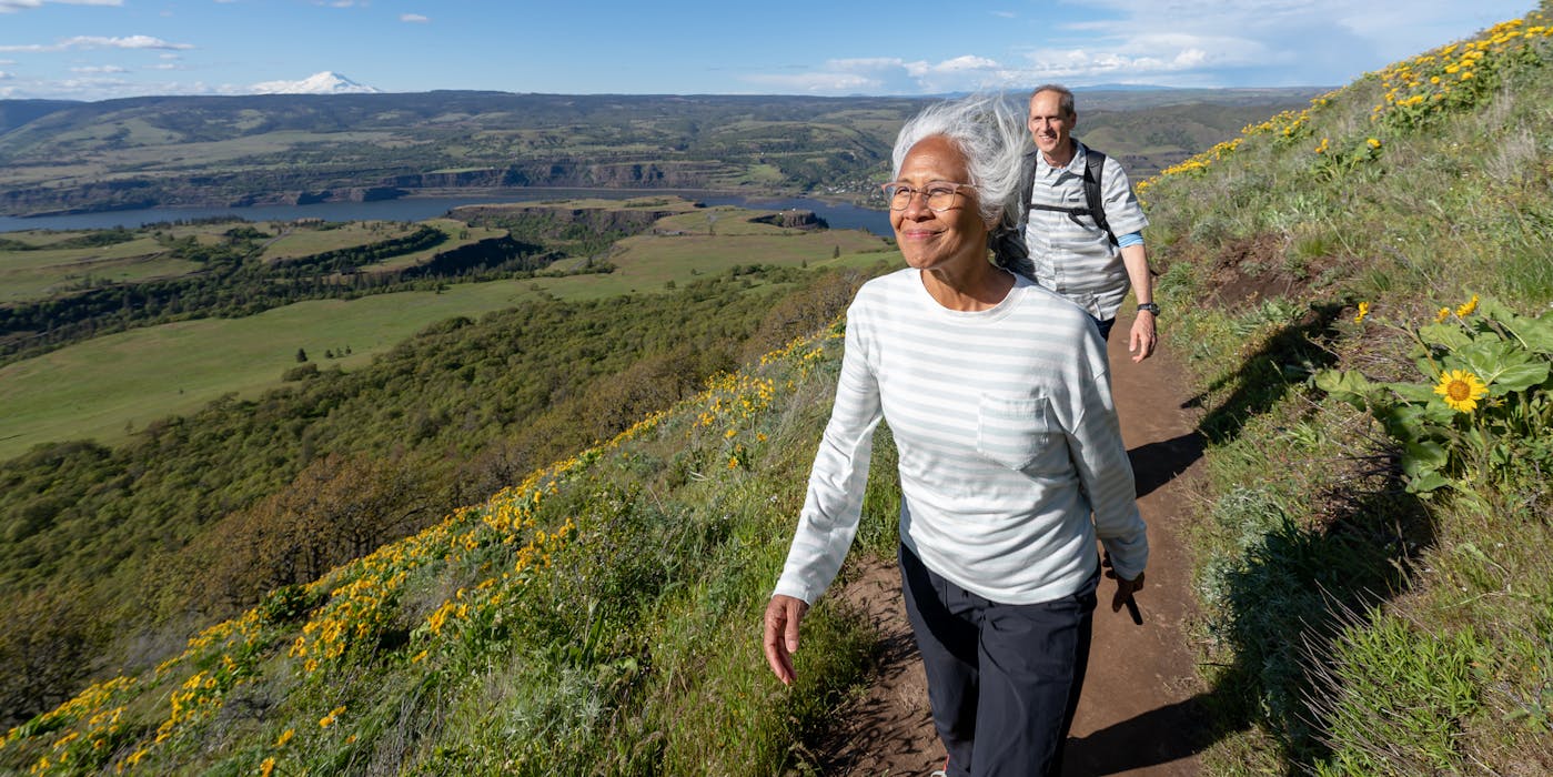 Mature Asian Woman Hiking on Hills