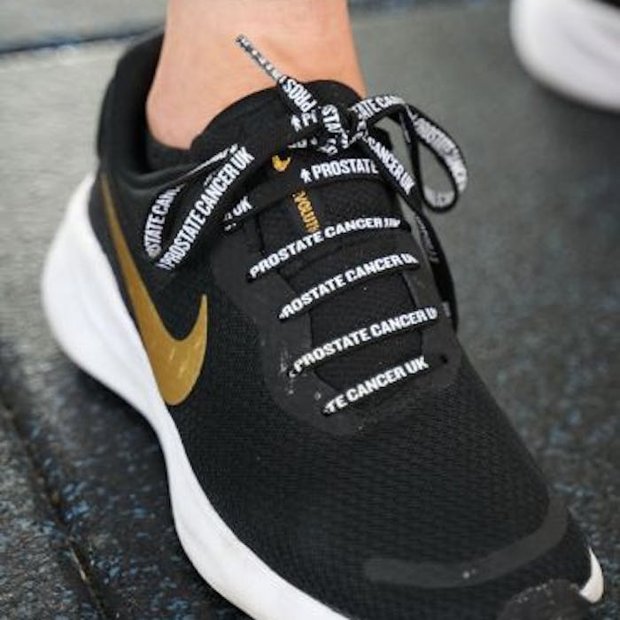 Close-up of a show with Prostate Cancer UK shoelaces.