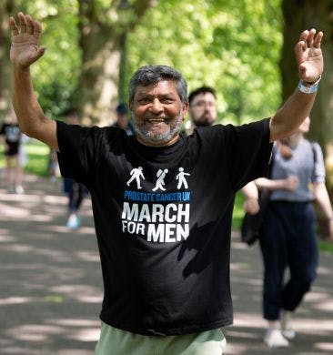 Man smiling wearing Prostate Cancer UK t-shirt