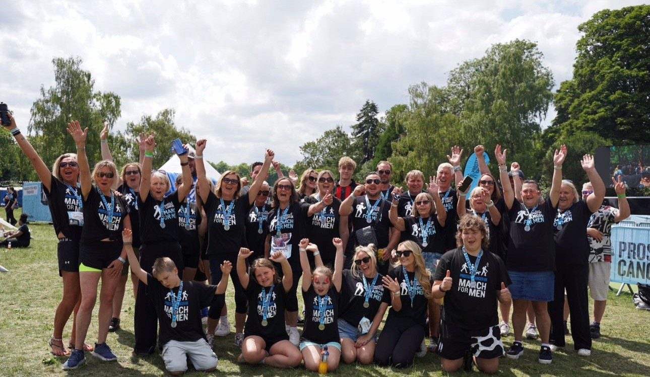 Photo of Lucy and her family at March for Men, all smiling and cheering