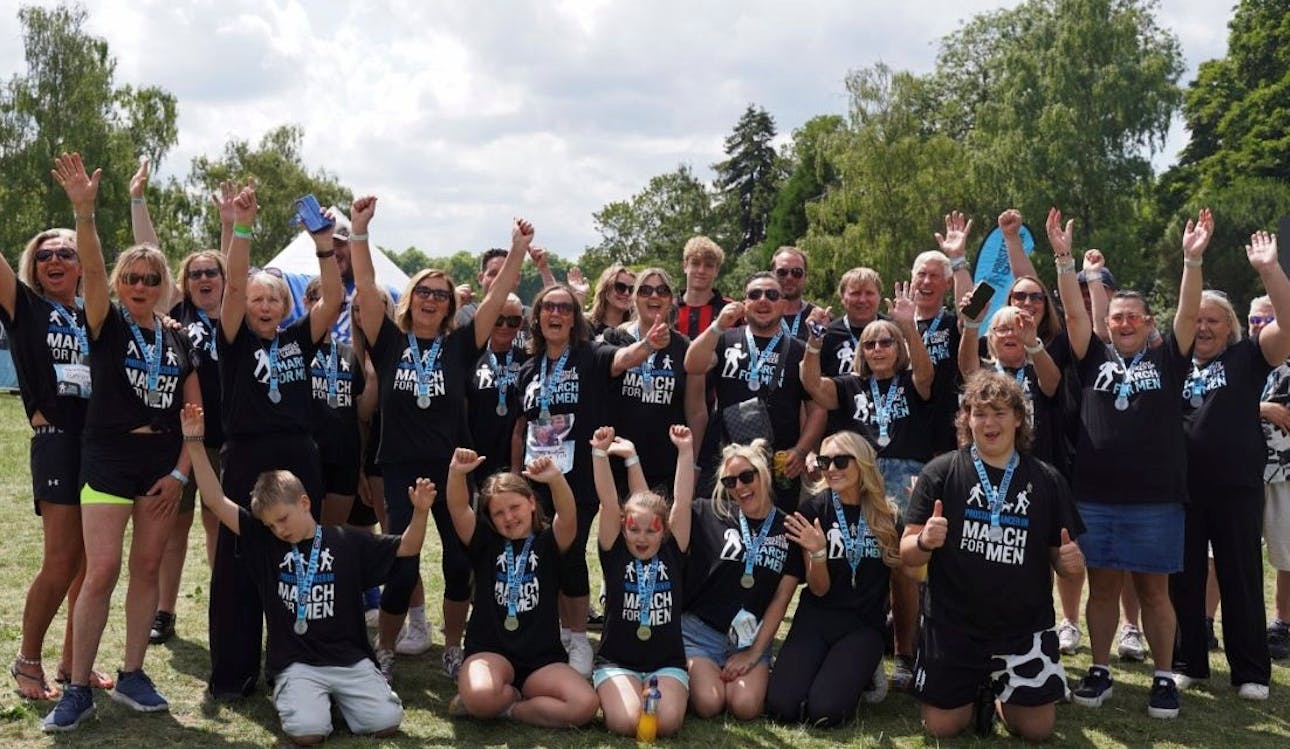 Photo of Lucy and her family at March for Men, all smiling and cheering