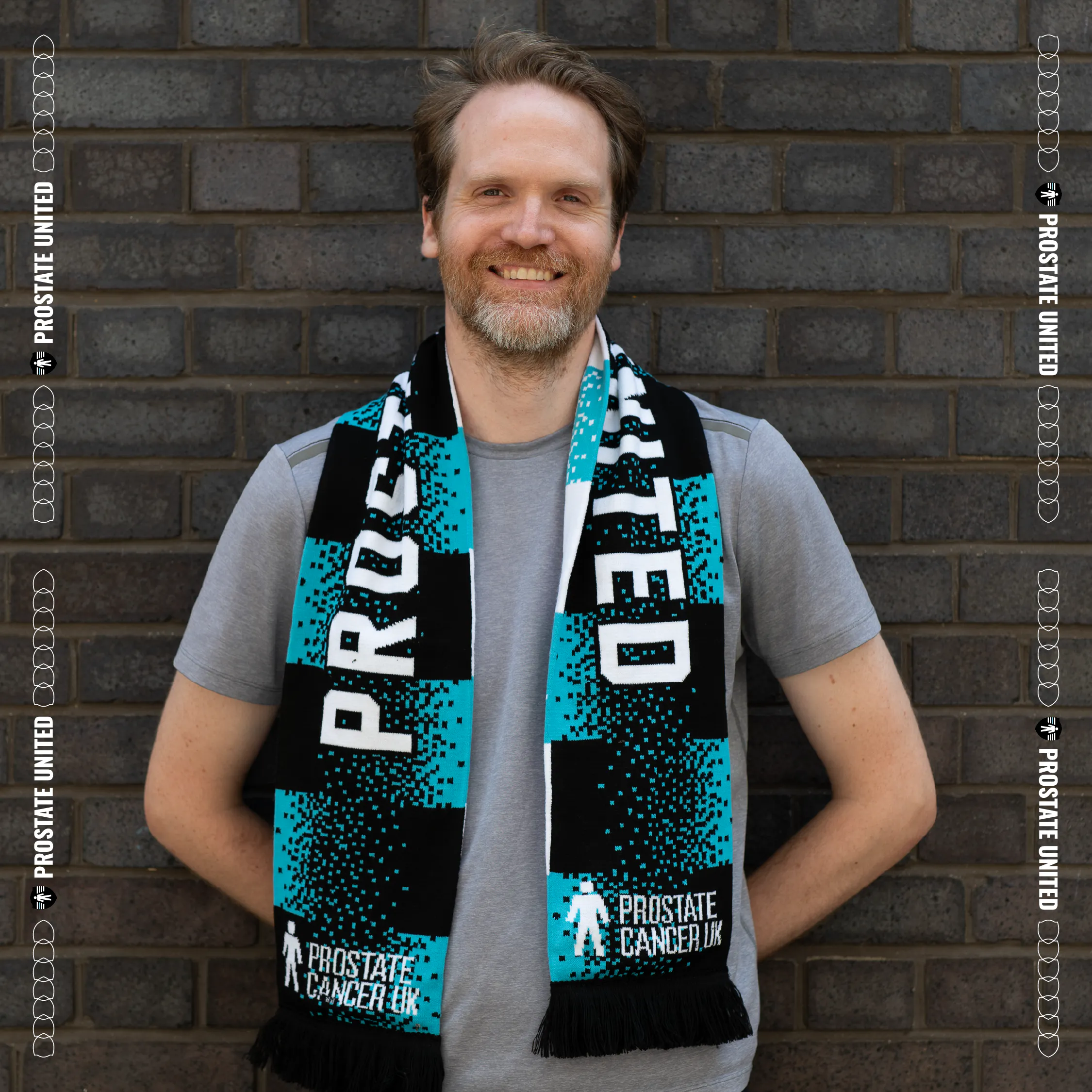 Person wearing a Prostate United branded scarf standing against a walloutdoors.