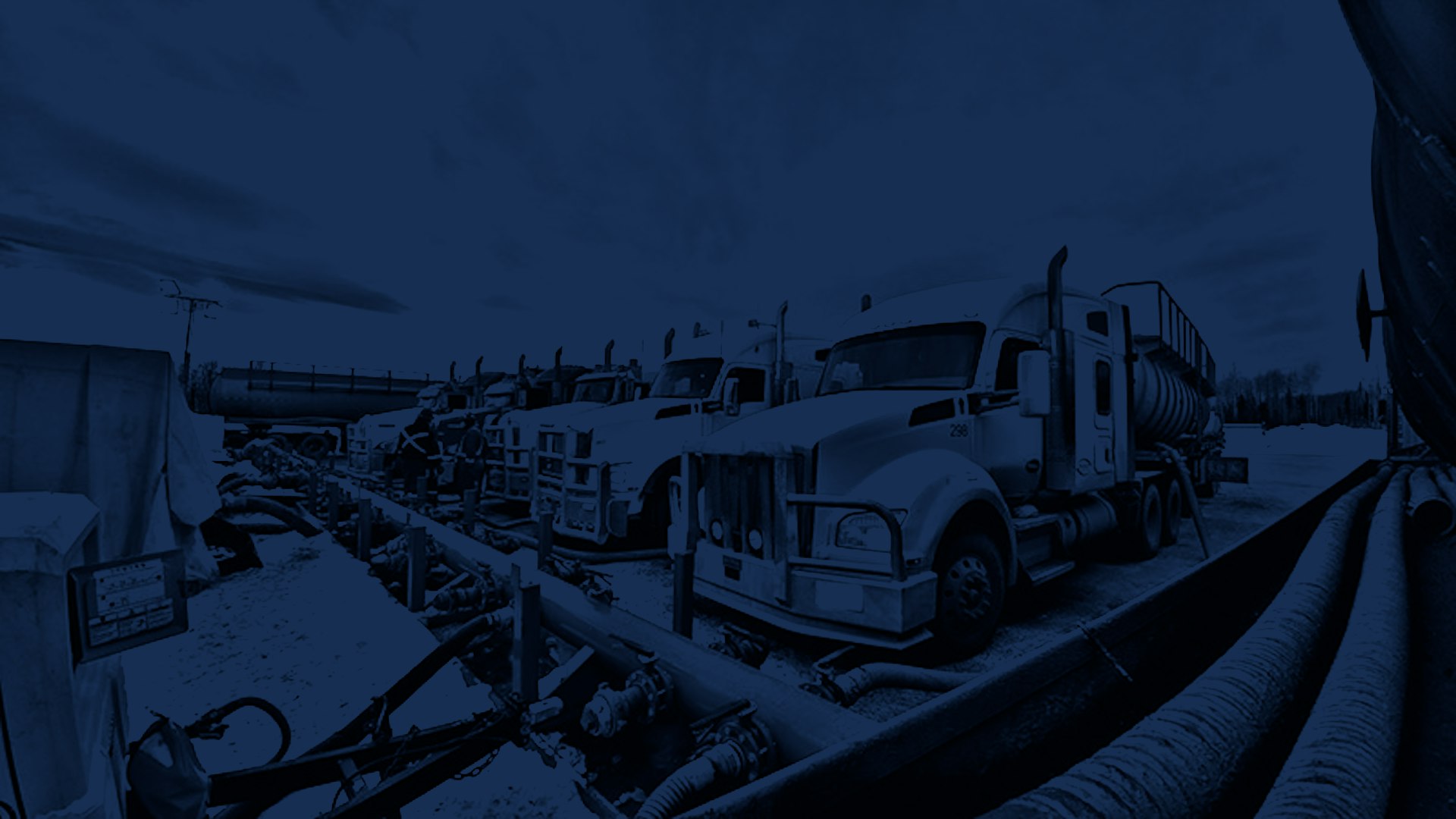 Group of Peaceland trucks supporting a frac operation