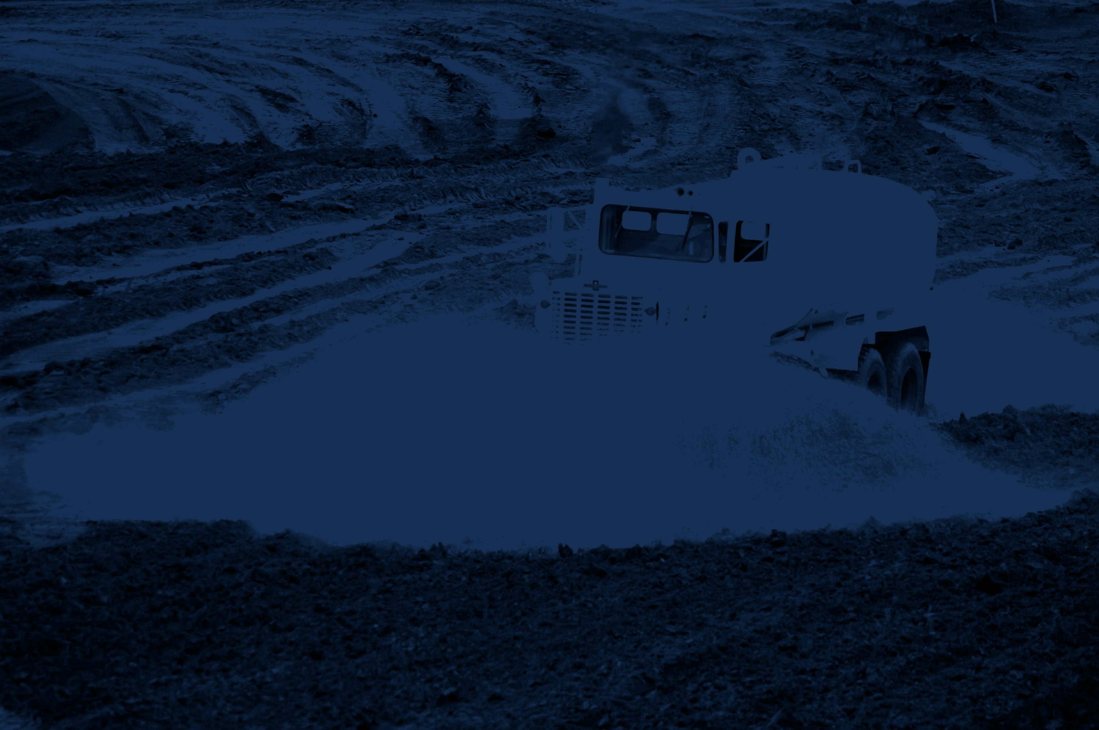 Peaceland water truck spraying down an oilfield lease