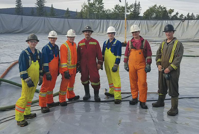 Peaceland team after building a lined holding water pond
