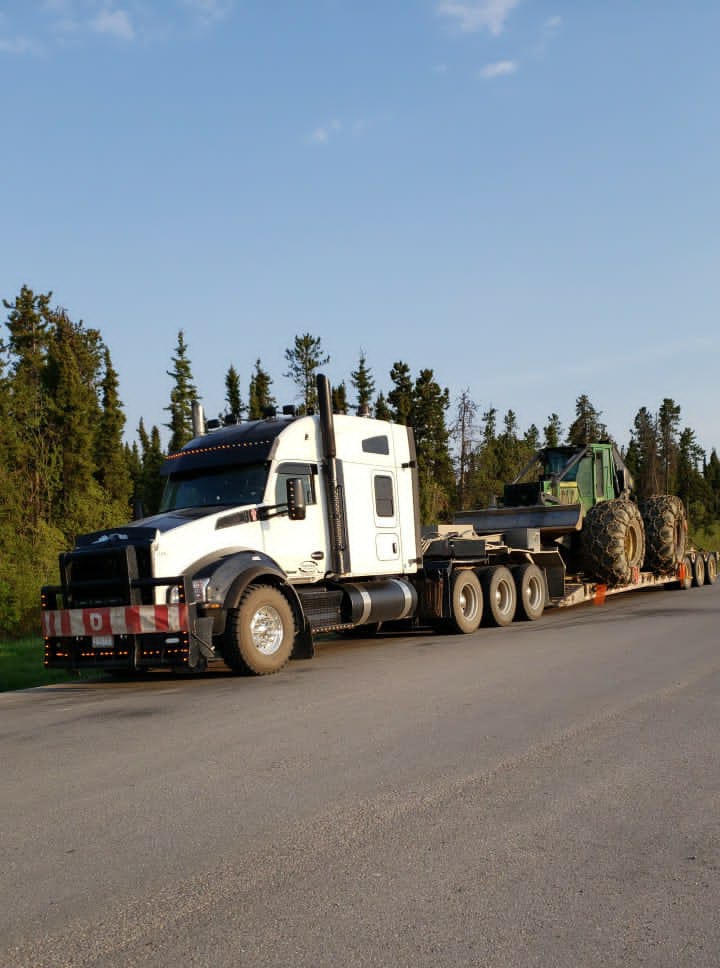 Peaceland truck hauling logging equipment