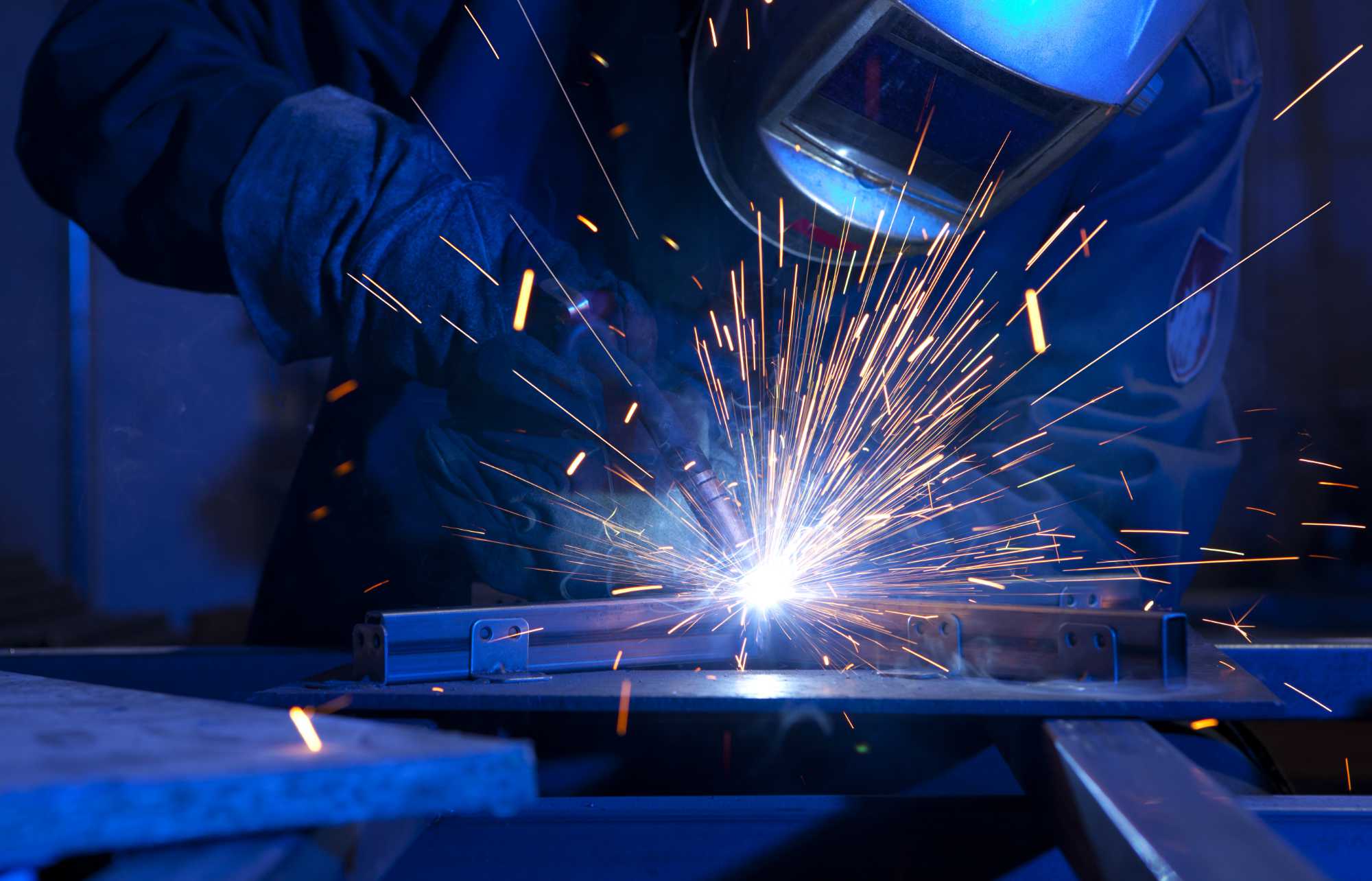 Peaceland welder fabricating a mount for an oilfield facility