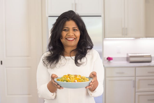 Chef Asha Gomez with her Weeknight Fancy Chicken and Green Bean Verraka