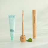 Pearlii products display photo showing Zero Waste Whitening Toothpaste, Mosobrush sitting in Mosobrush Stand and Mosobrush Case