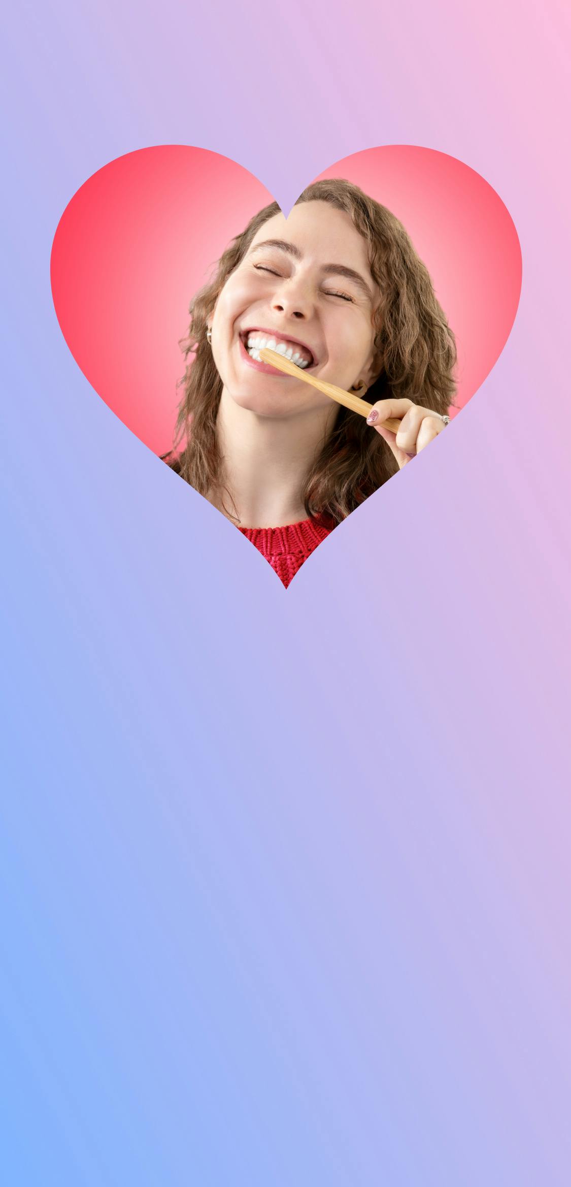 Close up photo of a woman brushing her teeth with a Pearlii Mosobrush, while smiling, inside the image of a heart.