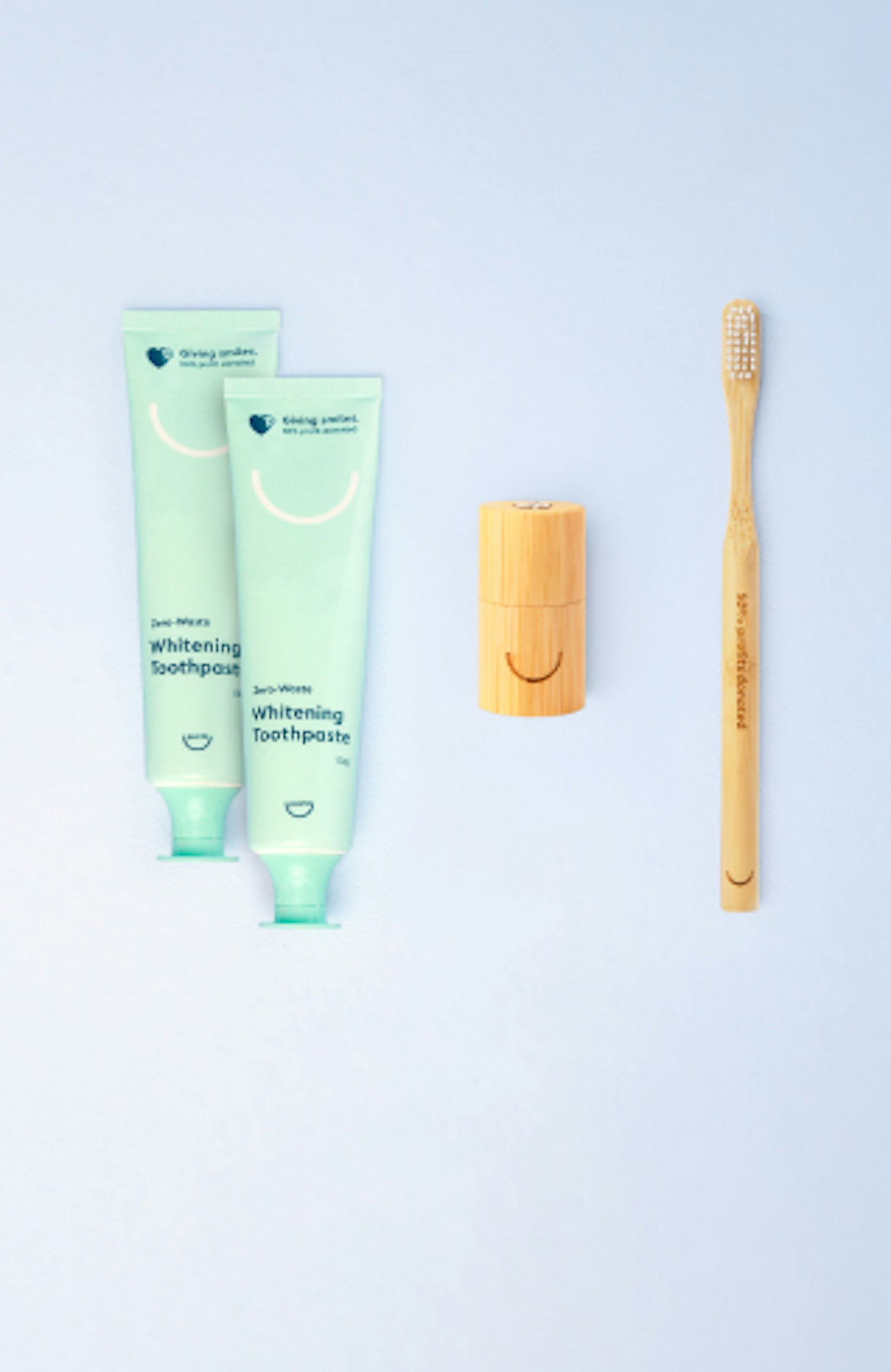 Marketing image of Pearlii products, showing the Essentials Pack, including: 1x Mosobrush, 2 x Zero-Waste Whitening Toothpastes, and 2 x Biofloss Easy Picks packs
