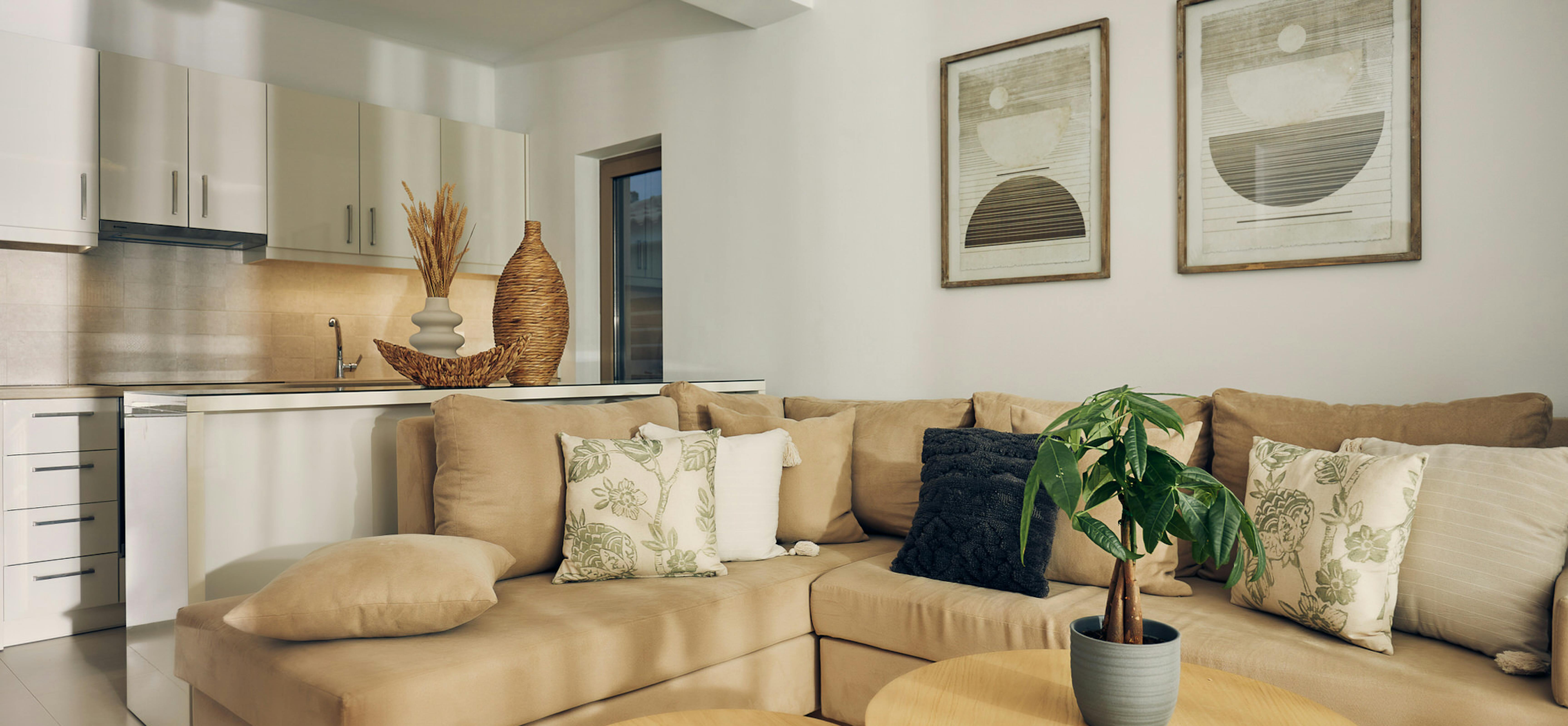 Modern media console with TV, woven floor lamp, raffia wall decorations, and potted palm beside wicker basket.