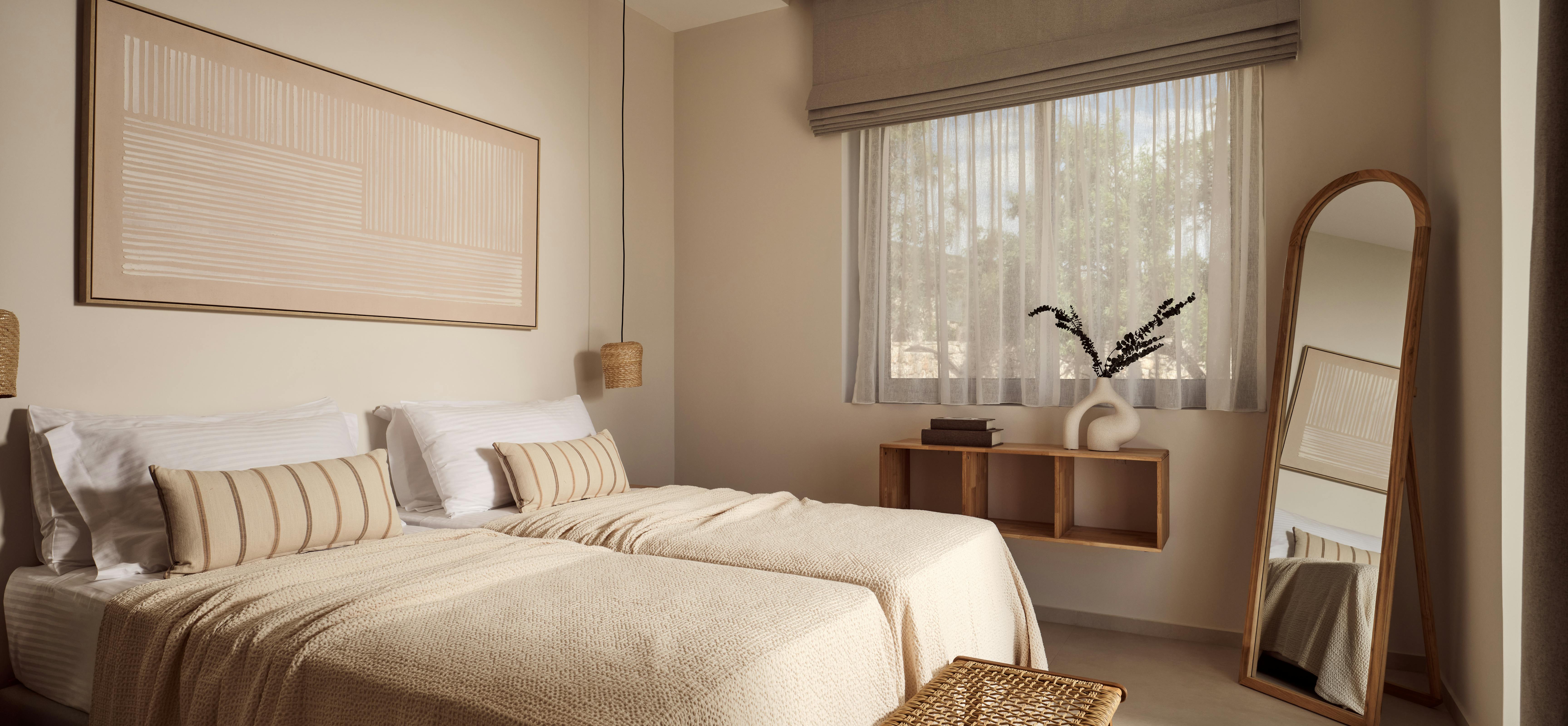 Minimalist bedroom with textured bedding, woven stool, and arched mirror reflecting natural light through window blinds.