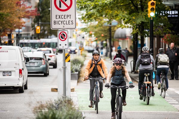 Commuters biking in bike lanes.