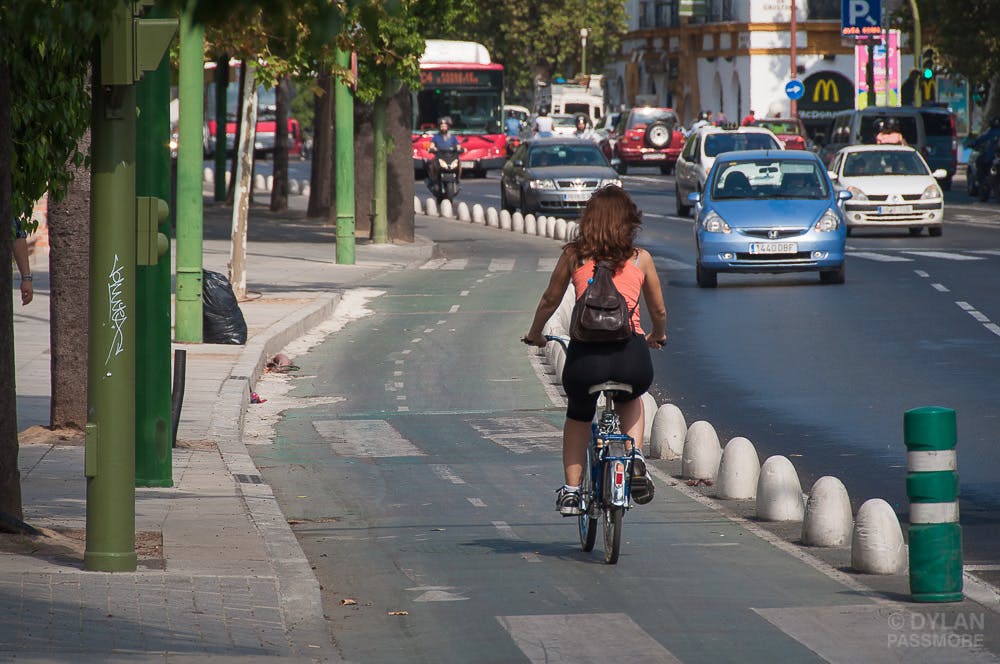 Biker using a dedicated bike lane in Sevilla.