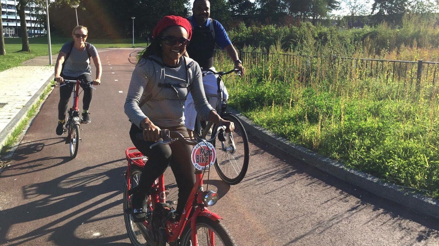 Roshun Austin, who first learned to bicycle at age 44, rides as part of a bike study tour in Amsterdam.