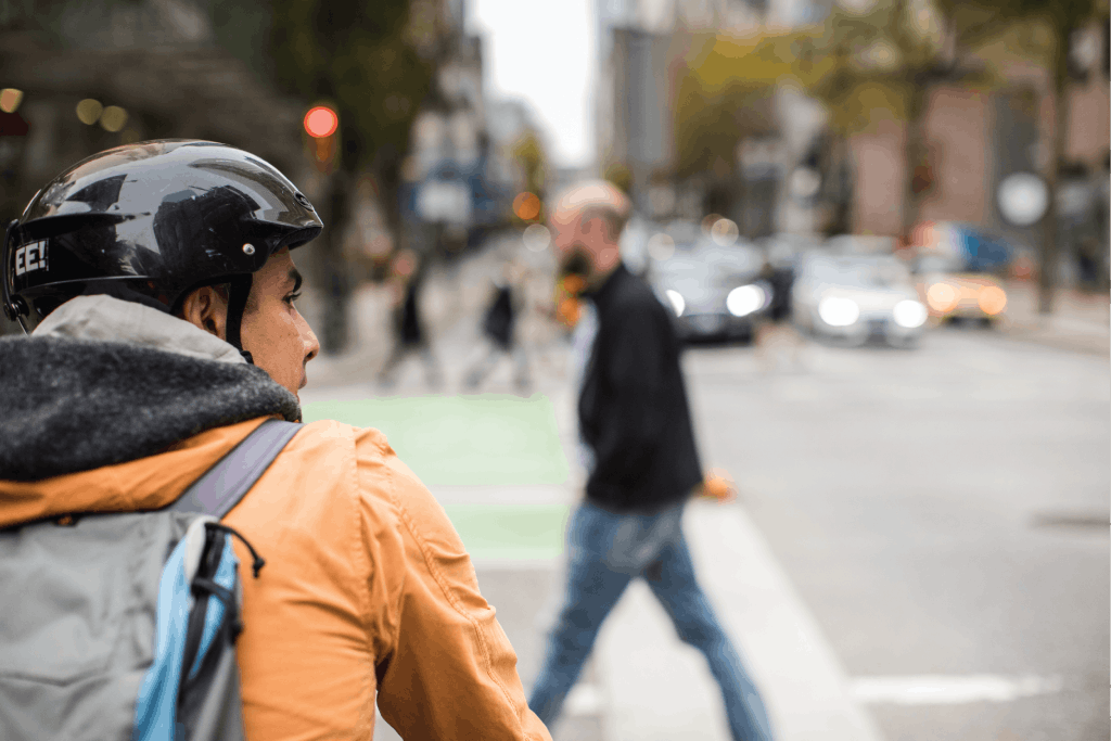 A cyclist waiting at an intersection.