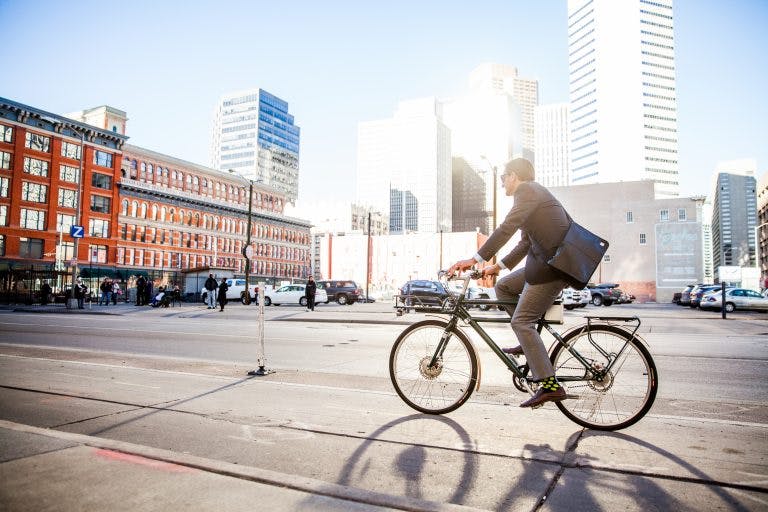 A worker commutes on an e-bike.