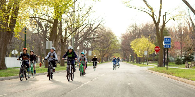 Kids riding down the street, Source: Norte, Beth Price.