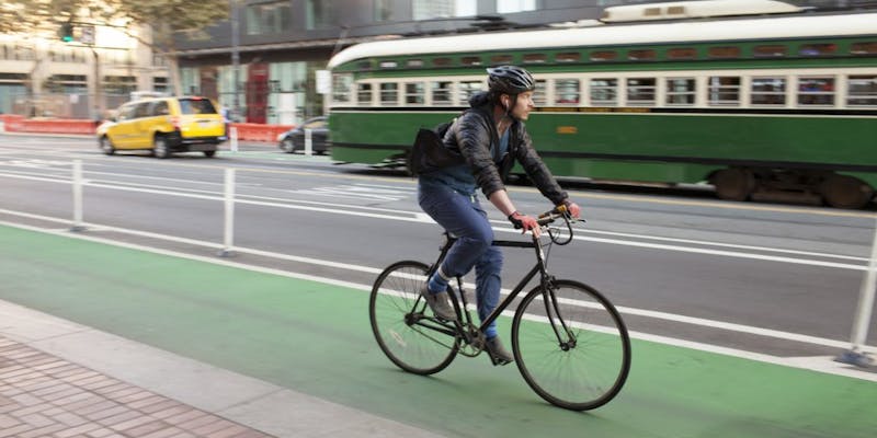Rider in green protected bike lane