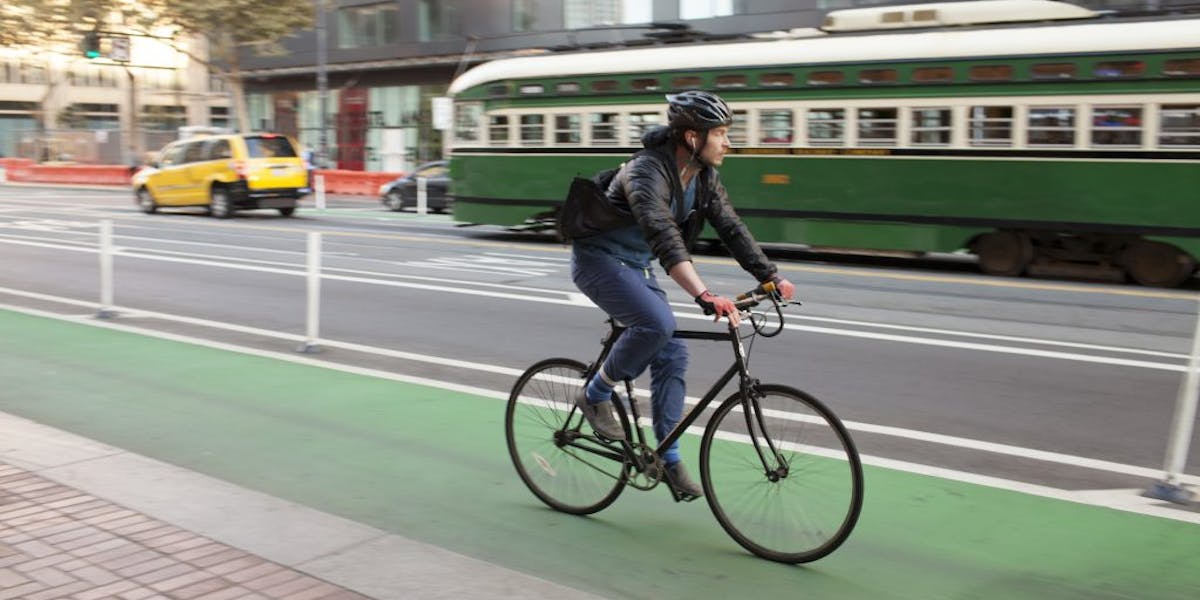 Rider in green protected bike lane