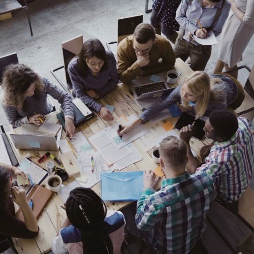 Conference table with people and docs