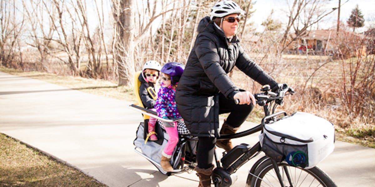 Woman on e-bike with her kids