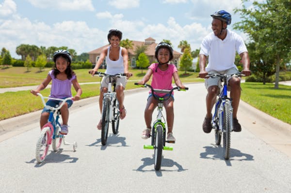A family takes a bike ride together.
