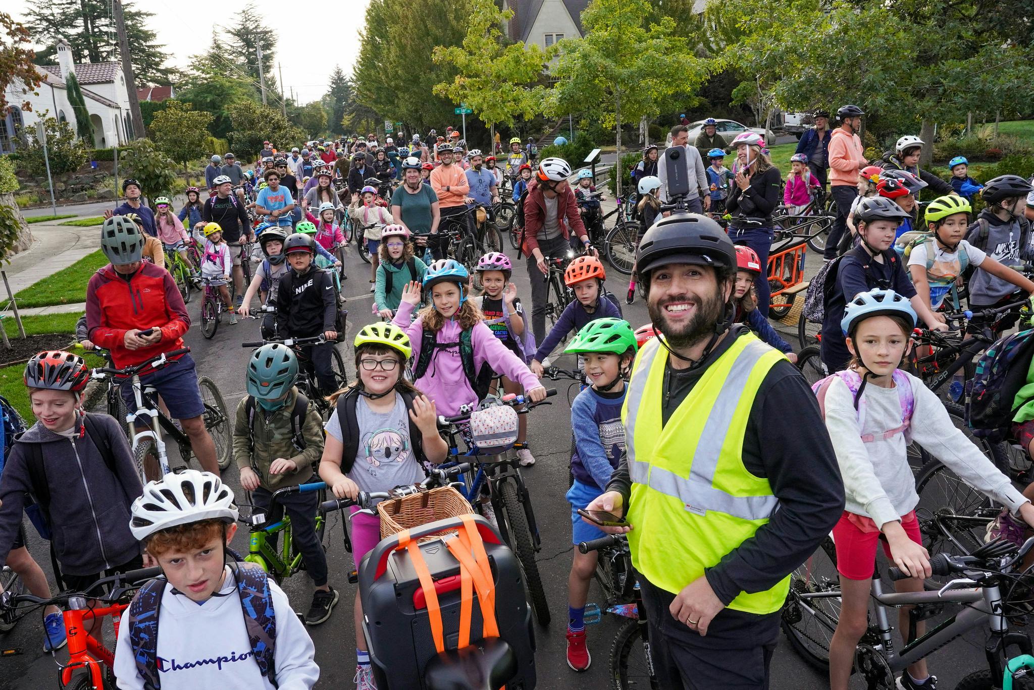 Wearing a yellow safety vest, Coach Balto leads a weekly “Bike Bus” for Alameda Elementary School students. (Photo credit: Jonathan Maus/BikePortland)