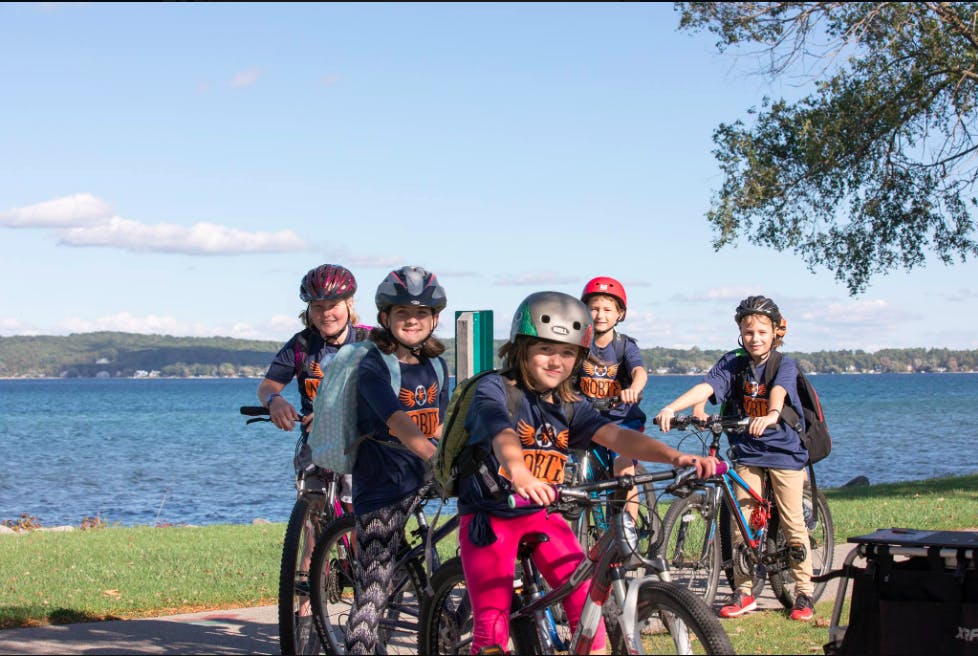 Kids riding by the park