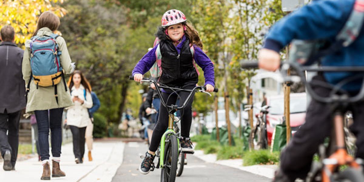 Child biking to school with backpack