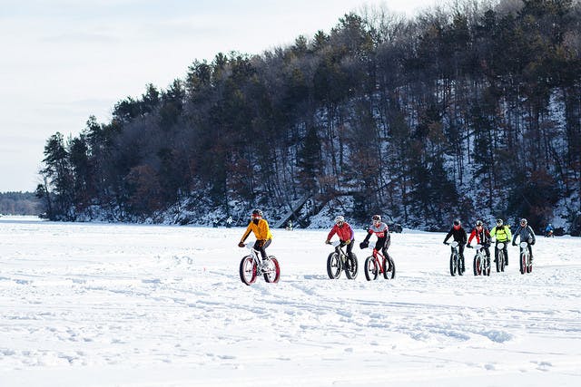 Bikers enjoy a snowy ride.