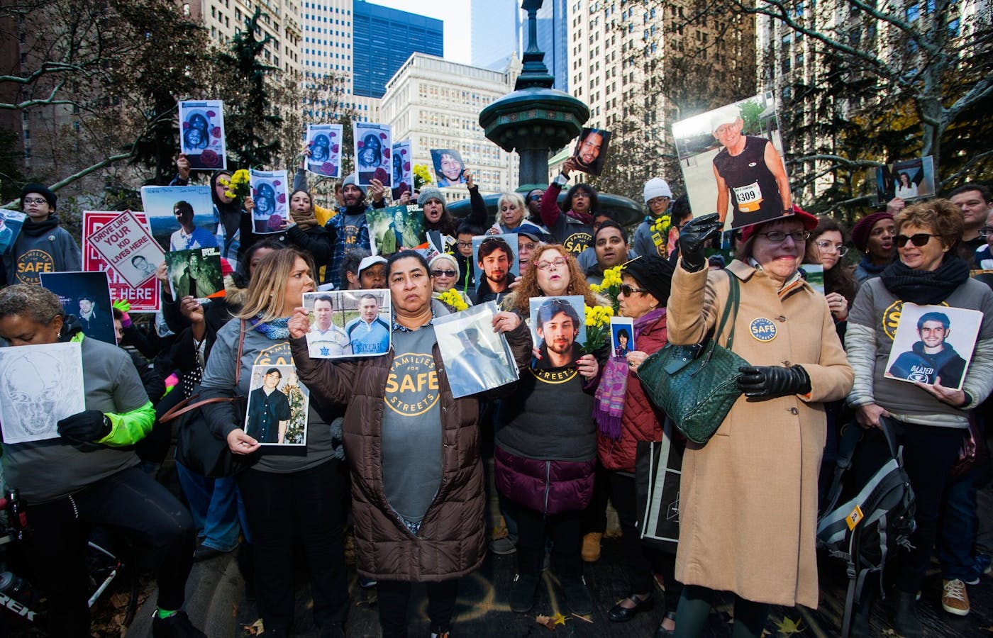 Members of the New York chapter of Families for Safe Streets protest with photos of their loved ones who have died due to traffic violence.