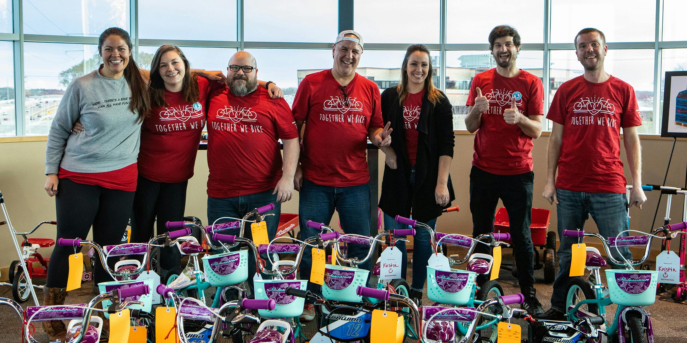 Members of the non-profit Together We Rise with donated bicycles.