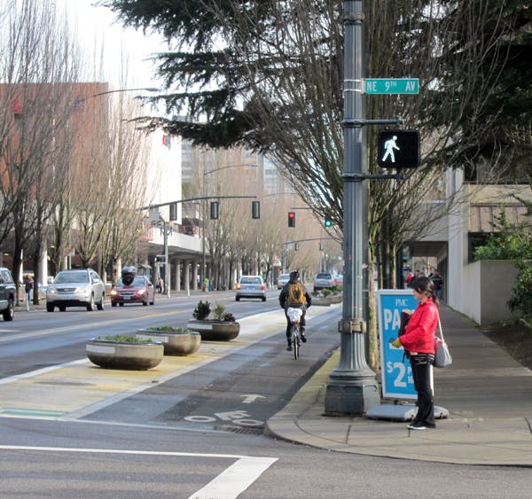 Bike lane with planter separators, by Michael Anderson