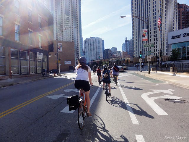 Cyclists waiting to turn left onto Kinzie from Milwaukee. Photo by Steven Vance.