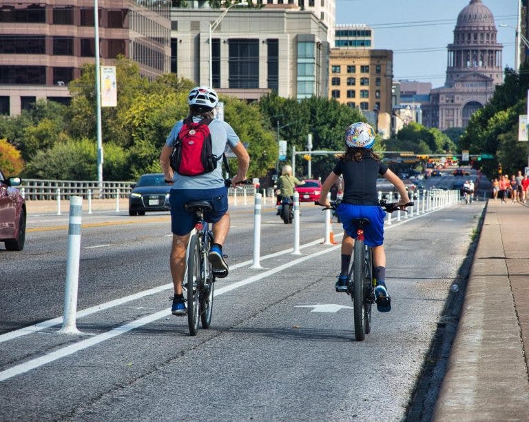 Bike riders on Austin’s South Congress Avenue take advantage of the fresh paint and new construction of protected bike lanes, created in response to the COVID-19 pandemic. On November 2, Austin voters approved Proposition B which included $30 million for future enhancements to this corridor. (Credit: Bike Austin)