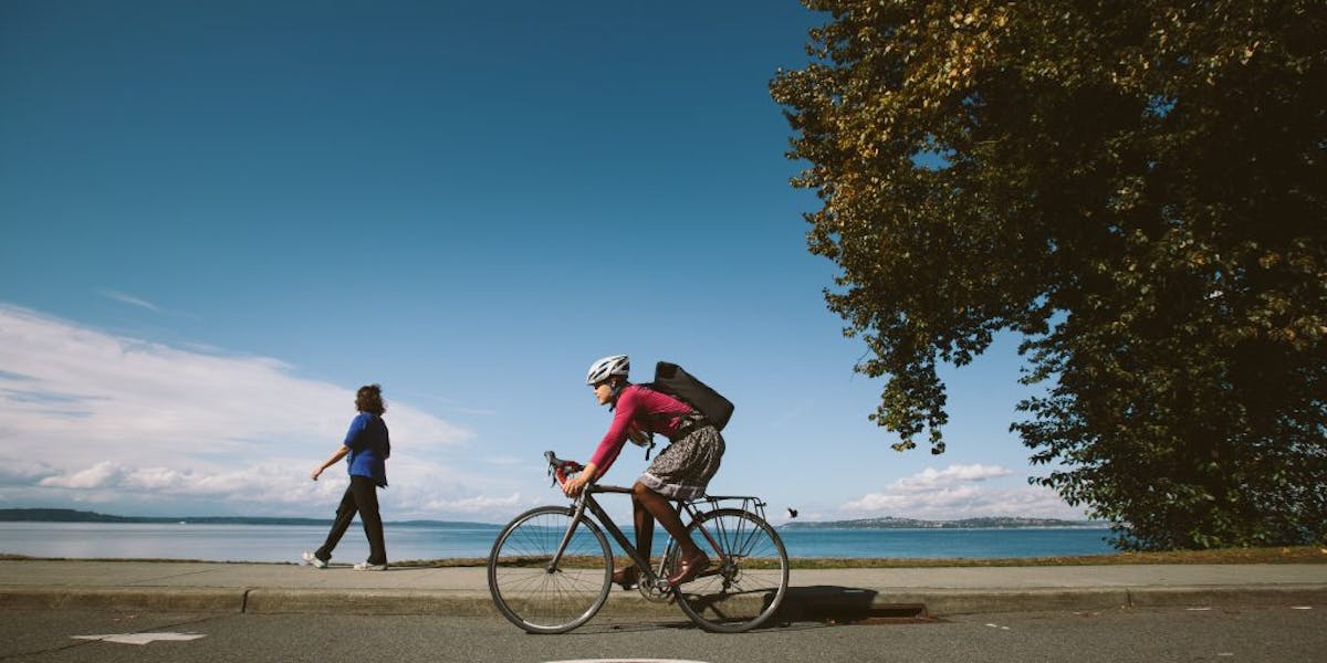 Bike commuter going by a lake