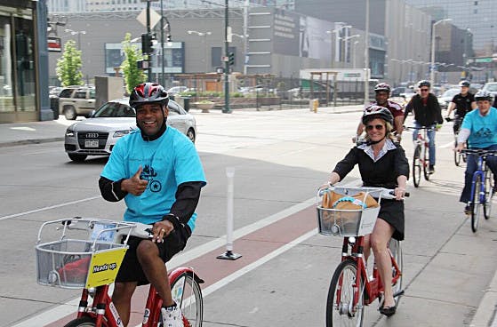 Denver Mayor Michael Hancock riding in a bike lane