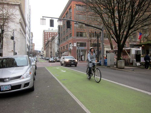 Green paint marks a bike lane on Oak Street in Portland.