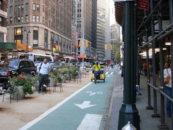 public seating acting as a barrier for bike lane, nyc