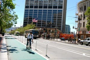 A green lane on Market Street equipped with safe hit posts.