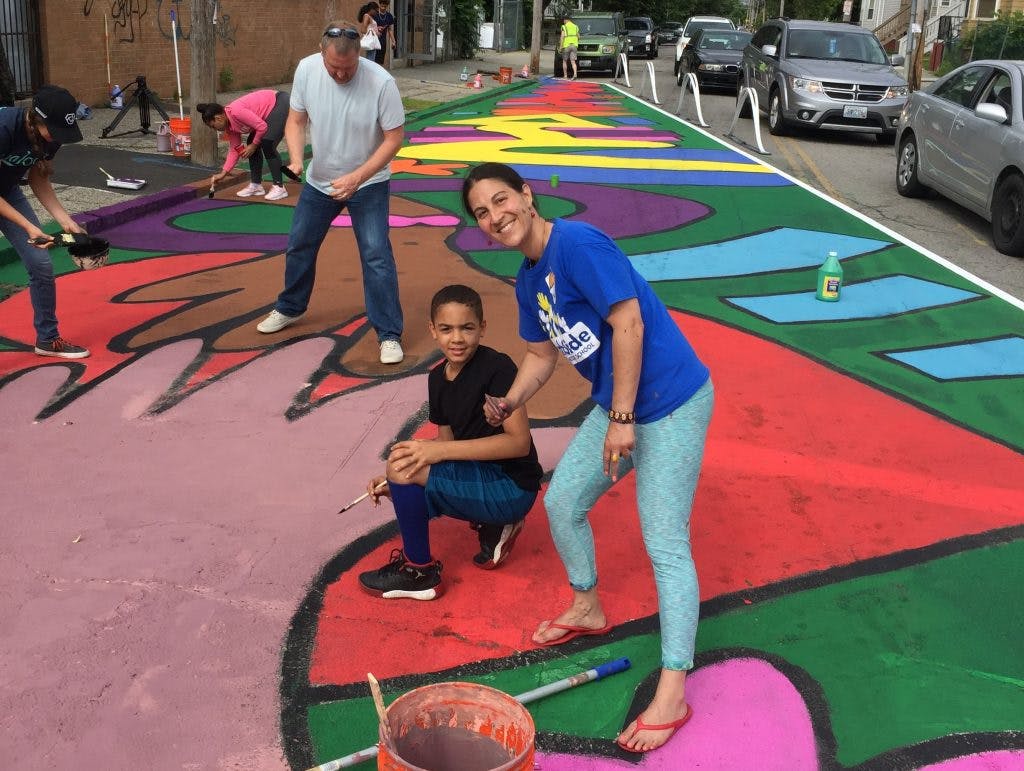 Community members picked up brushes and joined the efforts to paint murals to help show where prospective bike lanes would be built.