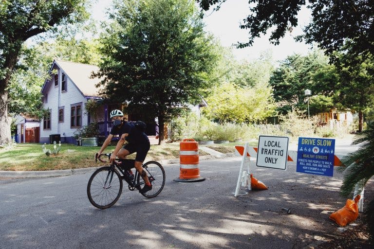 In June 2020, 10 miles of low-traffic areas were created along public streets with enough space to maintain safe physical distance for activities like walking and bicycling. Called “Healthy Streets,” these temporary closures on select local streets removed cut-through traffic while maintaining local access for residents, deliveries, and emergency vehicles. (Credit: Sid Law, MoveATX)