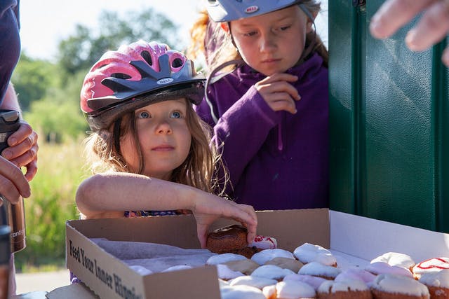 Girl samples donuts in Fort Collins