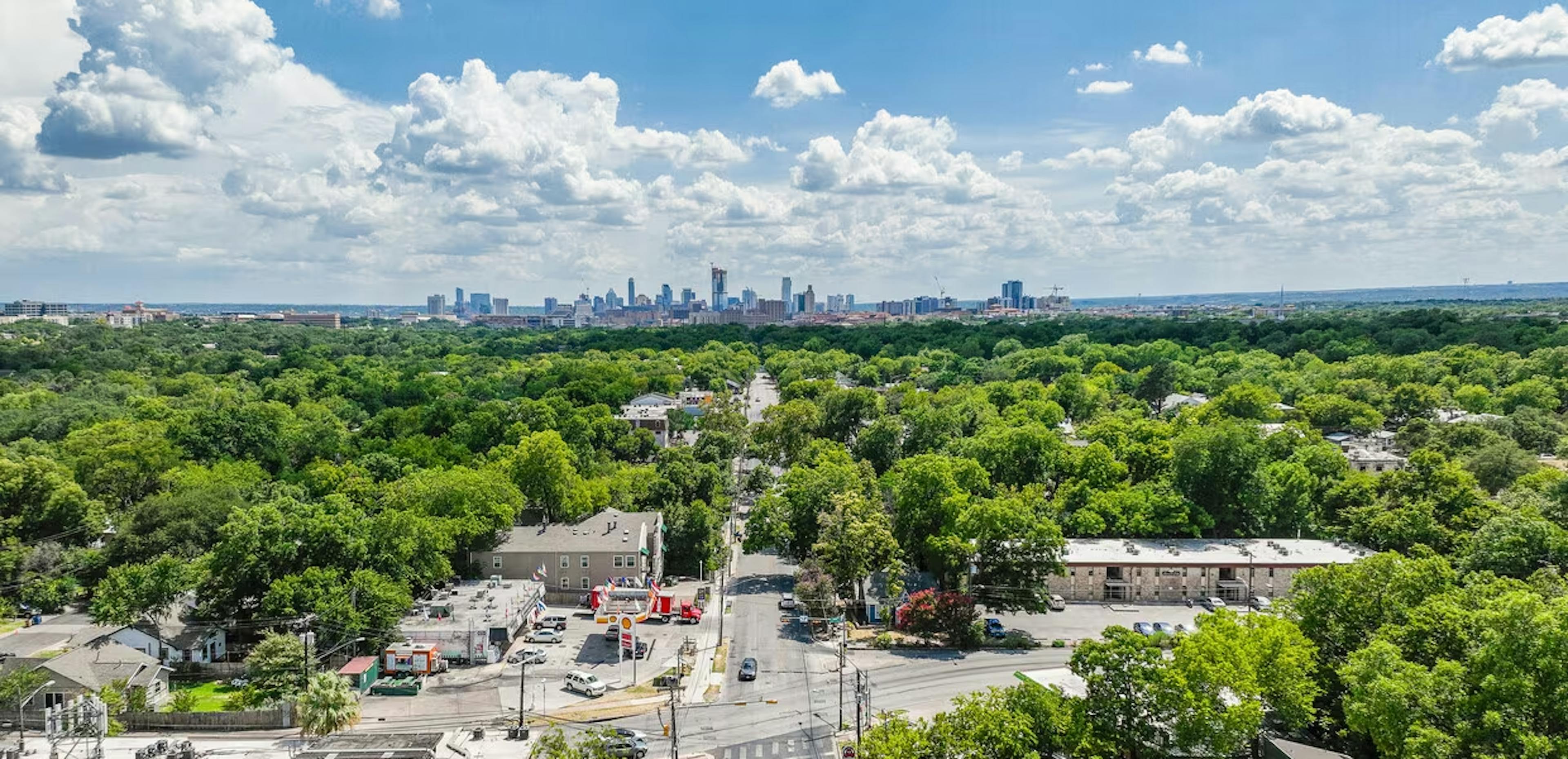 Panoramic aerial view of historic Hyde Park in Austin, Texas, showcasing tree-lined streets, Victorian homes, and a vibrant neighborhood. The lush greenery, architectural diversity, and community spirit of Hyde Park create a picturesque scene in the heart of Austin.